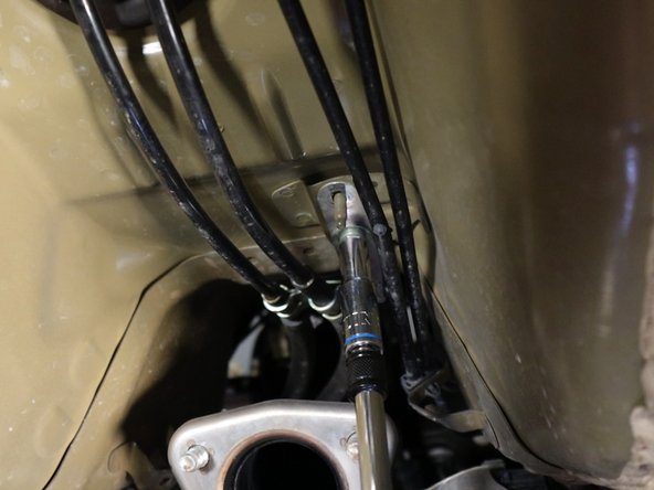 Unbolt the shifter cable mounting bracket.