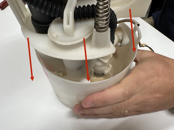 Slide the pump assembly into the housing. Be sure to secure all clips around the top of the case.