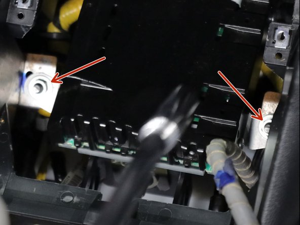 Remove the two 10mm nuts holding the stereo amplifier in place. Once removed, move the amp out of the way to expose the top of the shifter.