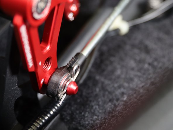 Install both shifter cable end links to the shifter. Use the supplied clip and washer on the RH side cable.