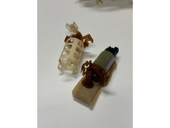 Unclip and remove the pump holder. This will separate the pump and filter from the outer cage.