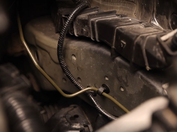 Unclip the clutch line and remove it from the car.