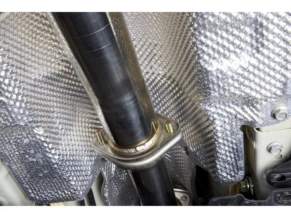 Use the supplied hardware and install the front pipe adapter.