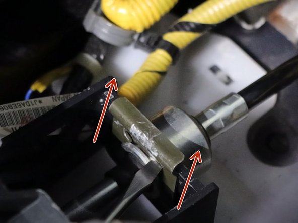 Use a flat-tip screwdriver and remove the two spring clips holding the shifter cables to the shifter.