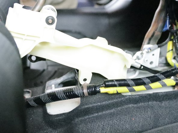 Use a pry tool and remove the wiring harness from the shifter.