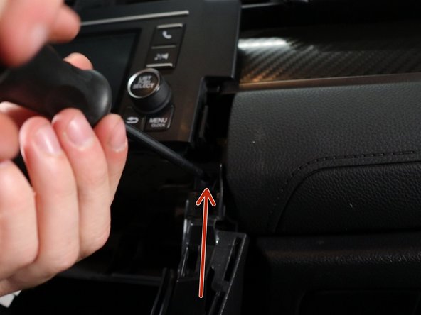 Remove the two phillips screws holding the side console trim sections in place.