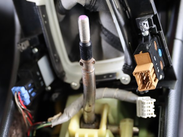 Locate both seat heater connectors and unplug them.