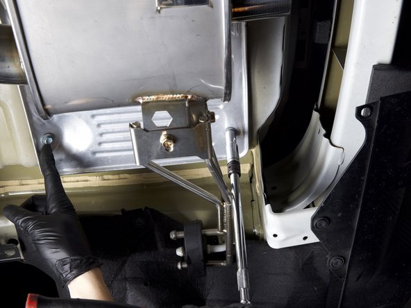 Prepare to install the valve controller by loosening the rear upper muffler heat shield.