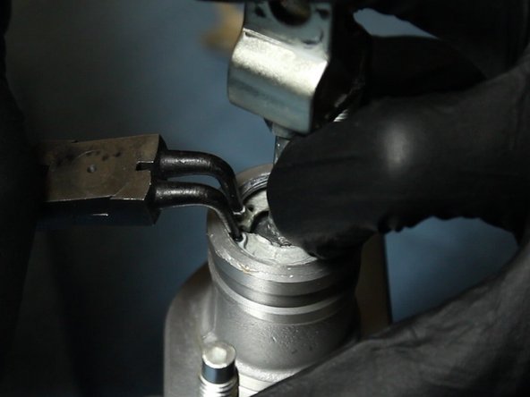 Using the C-clip pliers, insert the OEM rod &amp; fork into the EM1 CMC. The EM1 dust boot is optional.