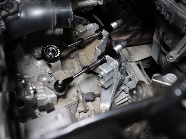 Then install the shifter cable spring clips that you removed earlier.