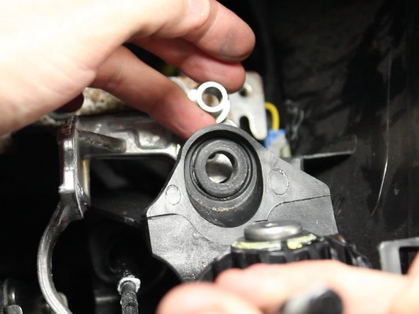 Push the metal base out of the rubber bushing.