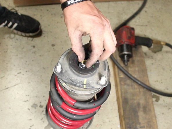 Install the new spring assembly and bolt the top hat assembly back to the strut.