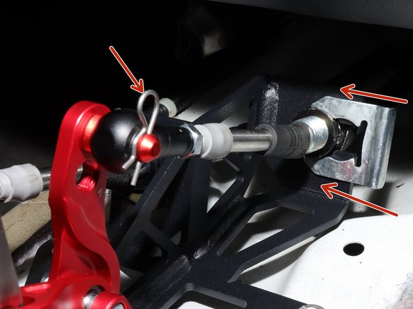 Finally, install the spring C clip to hold the shifter cable in place.