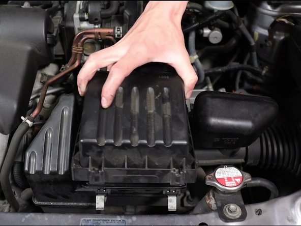 Remove the air box lid and then remove the air filter.
