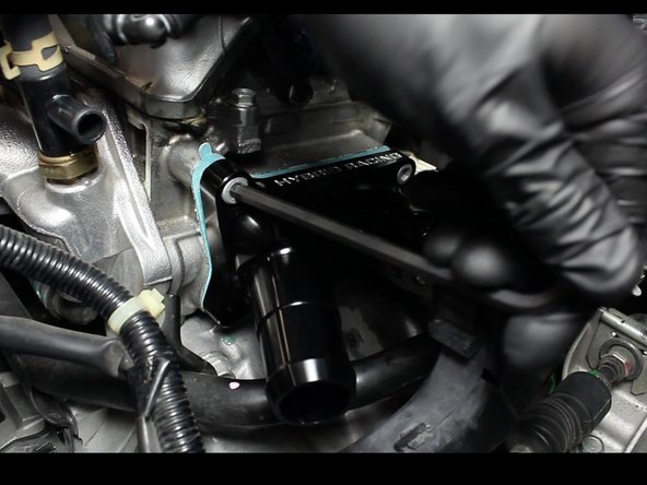 Install the new coolant port housing and tighten them in a crossing sequence.