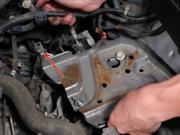 Unclip the wiring harness connector and remove the harness from the battery tray bracket.