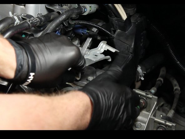 Remove the wiring harness bracket from the coolant housing.