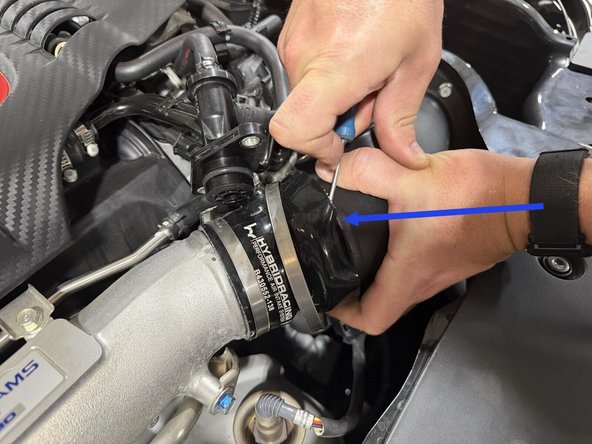 You can use a small flathead to help pull the silicone over the inlet.
