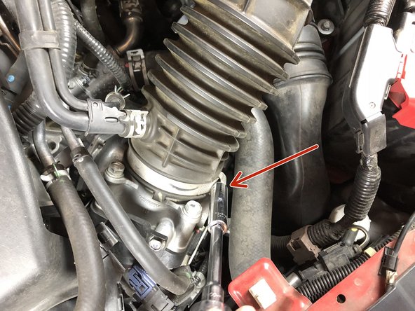 Unbolt the clamp on the end of the air intake pipe.