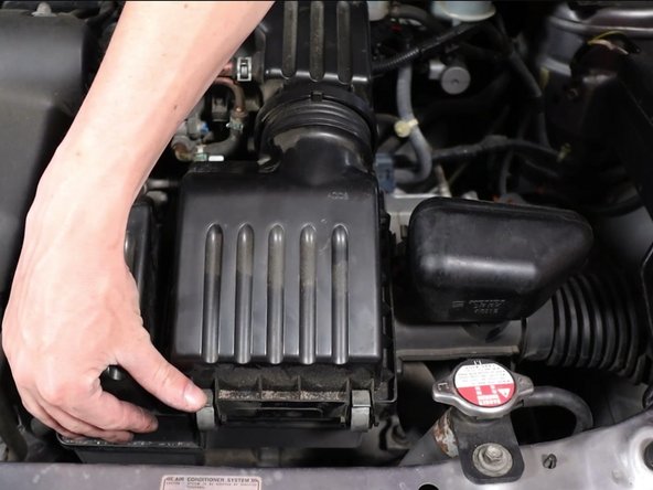 Unclip the four clips holding the airbox lid in place.