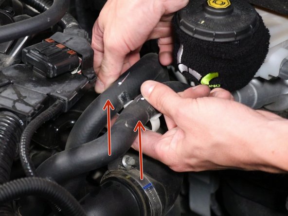 Loosen the air inlet tube and remove it. Be sure to move the hoses out of the way.