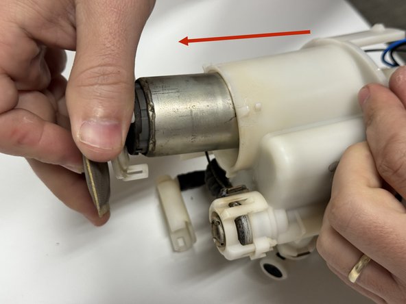 Unclip them and slide the entire fuel pump motor out of the case.