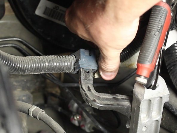 Un-clip the factory wiring harness from its mounting bracket.