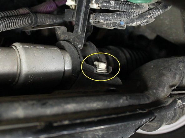 Remove the two 14mm bolts that hold the sub-frame harness to the steering rack.