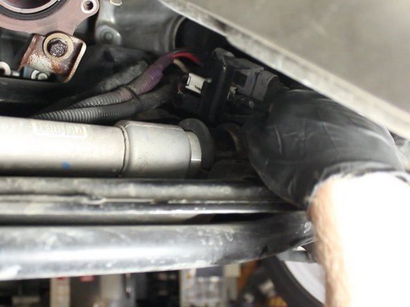 Lift the bracket away from the steering rack and push towards the engine and tuck it out of the way. This will aid in the removal of the factory exhaust manifold.