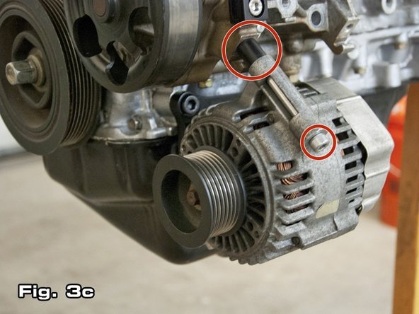 Once the alternator bracket has been bolted up, begin mounting the alternator by inserting the supplied 100 mm M8x1.25 bolt through the upper alternator mounting hole. Use n 6 mm allen wrench to tighten this bolt. This bolt should thread into the block where the top left mounting bolt for the A/C compressor originally went (as shown in Figure 3c).