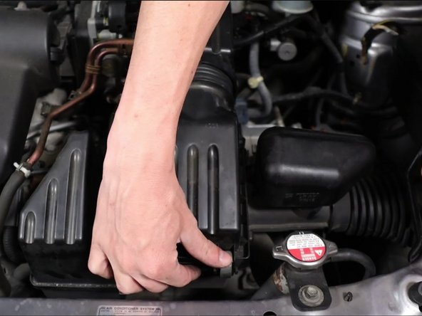 Remove the air box lid and then remove the air filter.