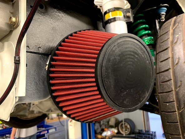 Slide the silicone tube through the lower clamp and install the plastic velocity stack. Tighten the lower clamp onto the velocity stack.