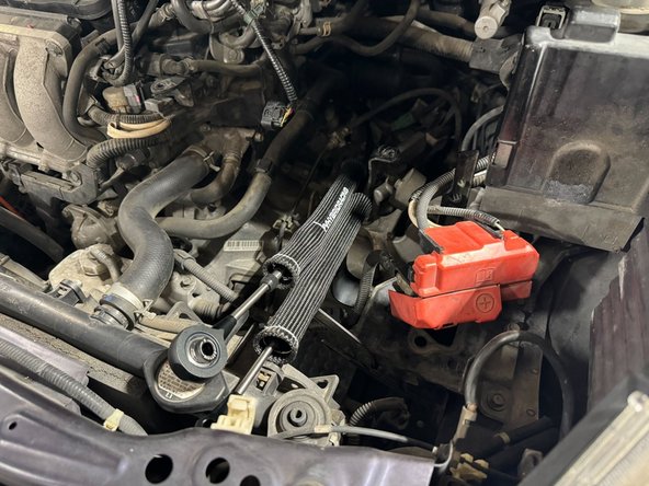 Once cables are not hanging out of engine bay, move to underside of car to feed cables into cabin from the exhaust tunnel.