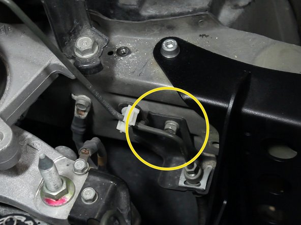 Remove the bolt holding the factory clutch line bracket in place.
