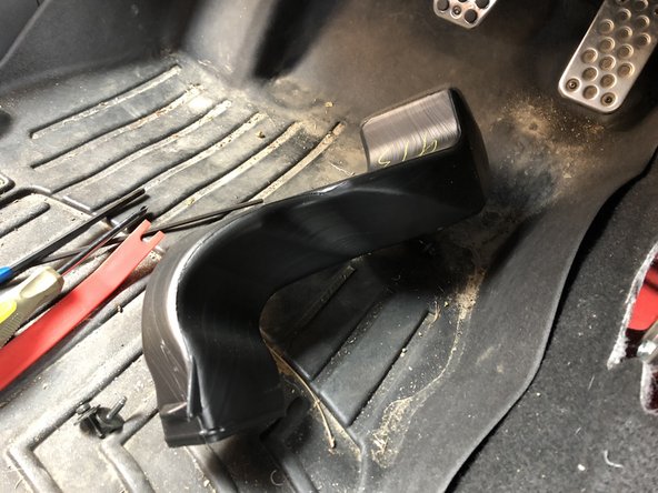 Remove the AC duct near the front of the shifter assembly.