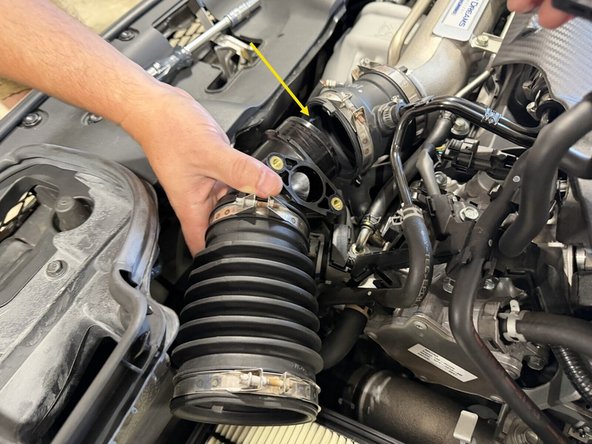 Loosen the clamps at the turbo inlet and work the tube free, then pull it out of the bay.