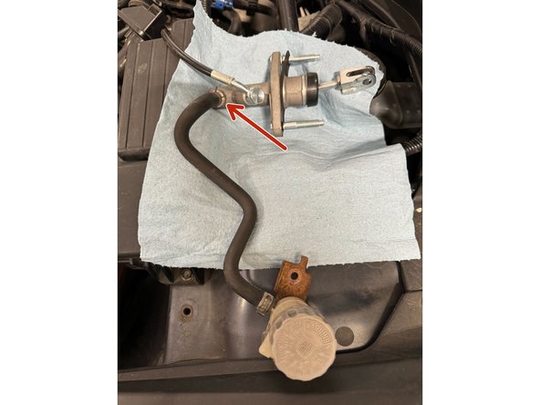 Using pliers, loosen clamp on reservoir hose at the CMC. Then immediately move hose to new CMC.