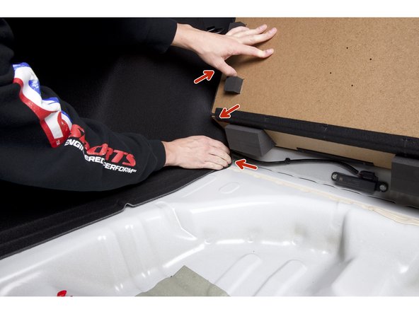 Feed the wire though the rear panel and then under the corner of the rear seat.