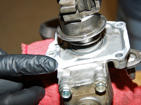 Now that we have the new springs installed, we can re-install the shifter arm assembly back in the transmission.