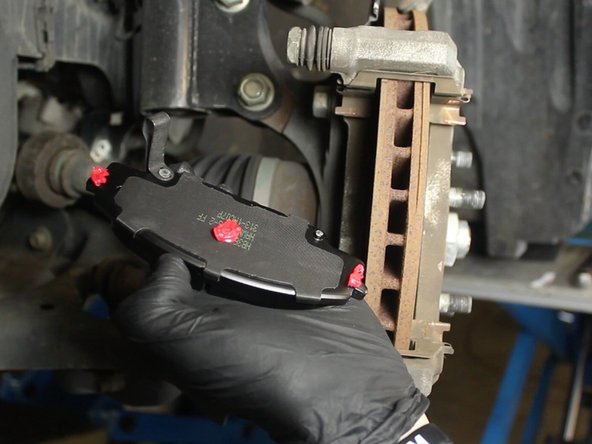 Apply a small amount brake pad lubricant to the back of each brake pad and to each end where the pad makes contact to the caliper.