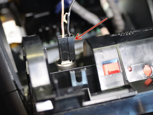 The lower coin pocked is held in with (x4) phillip screws. Two on top, two on the bottom. Remove all of them and the unplug the 12v socket on the back.