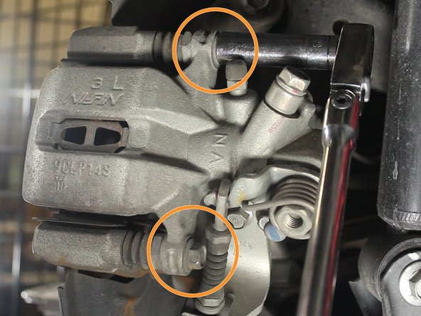 A wrench may be required to hold the inner locking nut on each bolt of the caliper. 