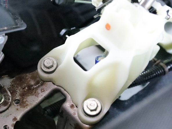 Use a 12mm socket and remove all four bolts that hold the shifter in place. Remove the shifter from the car.