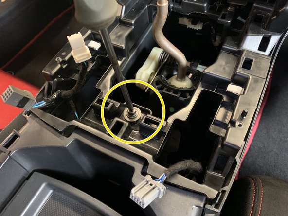 Next, remove the center console screw.