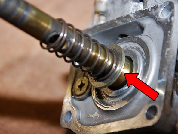 The gear selector is under spring pressure so start by holding it back with your hand then using your 12mm boxed end wrench to remove the M8 bolt as illustrated in Fig 10A.
