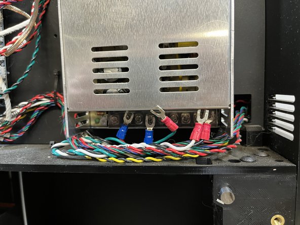 Lift the plastic cover that protects the wire terminals on the power supply.