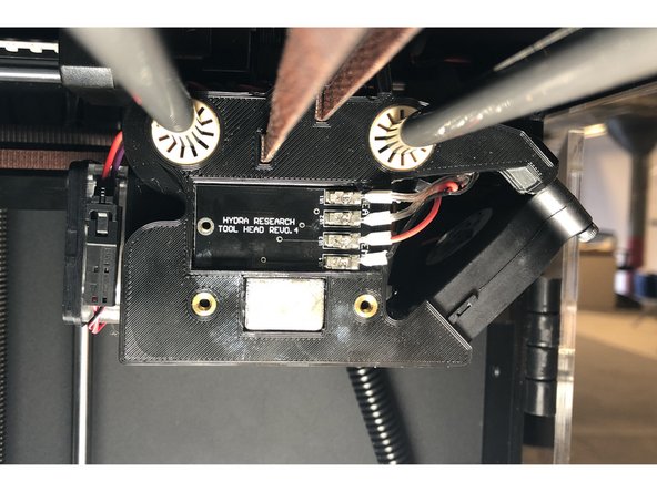 The PCB is properly seated when the hole in the PCB aligns with the threaded insert in the Tool Head