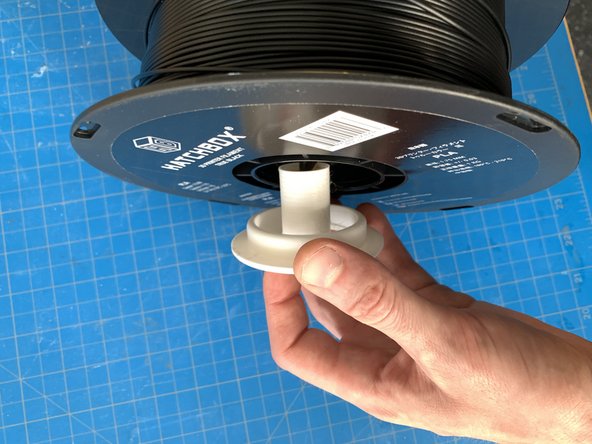 Take the new reel of filament and replace the hub through the center, as it was on the previous reel.  Make sure it is tight enough that the reel won't spin on the hub.