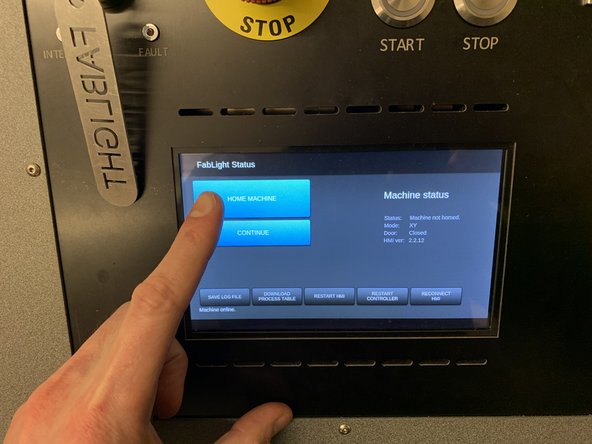 Pull the table back to its original position until it clicks into place, and close the front cover.