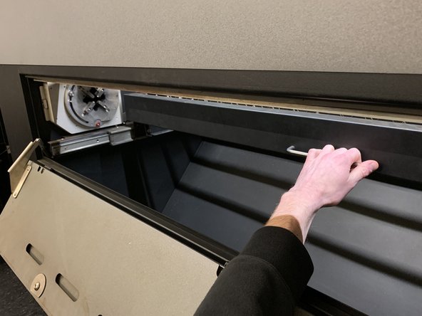 Once opened, grasp the handle of the work table and push it back into them machine until it clicks into its second position.